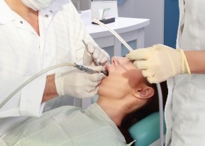 Young woman with dentist in a dental surgery.